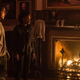 Three characters from Y: The Last Man (Yorick, Agent 355, and Dr. Mann) stand in front of a roaring fireplace.